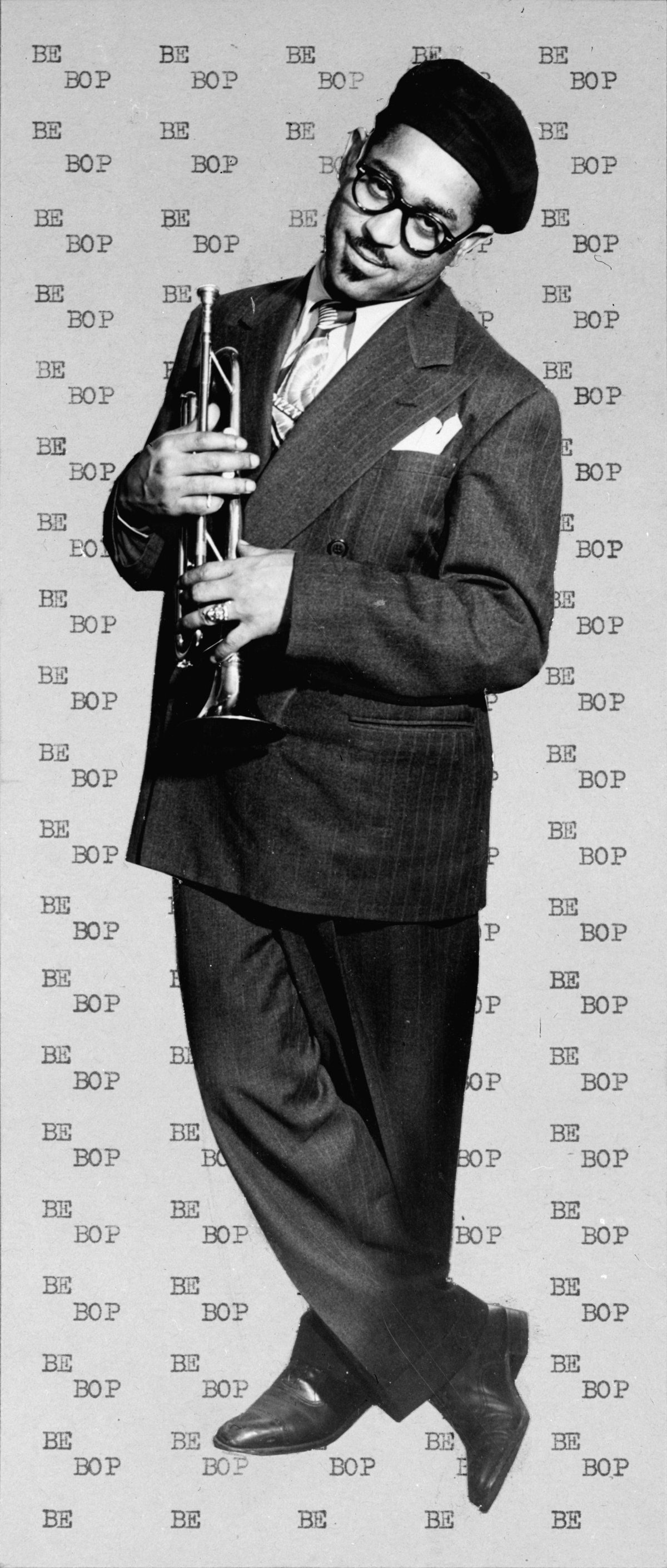 Dizzy Gillespie in a suit and beret, holding his trumpet, photographed by William P. Gottlieb in 1947